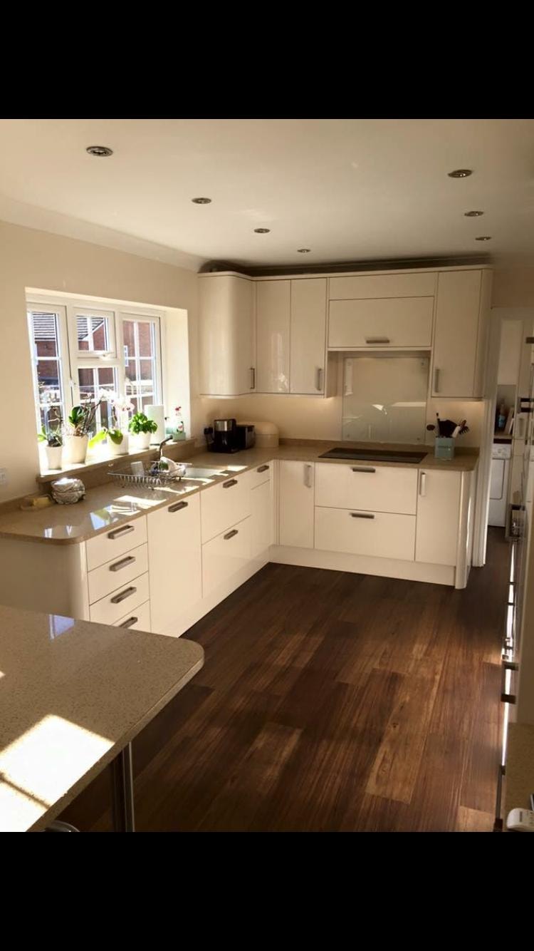White gloss kitchen with hardwood flooring