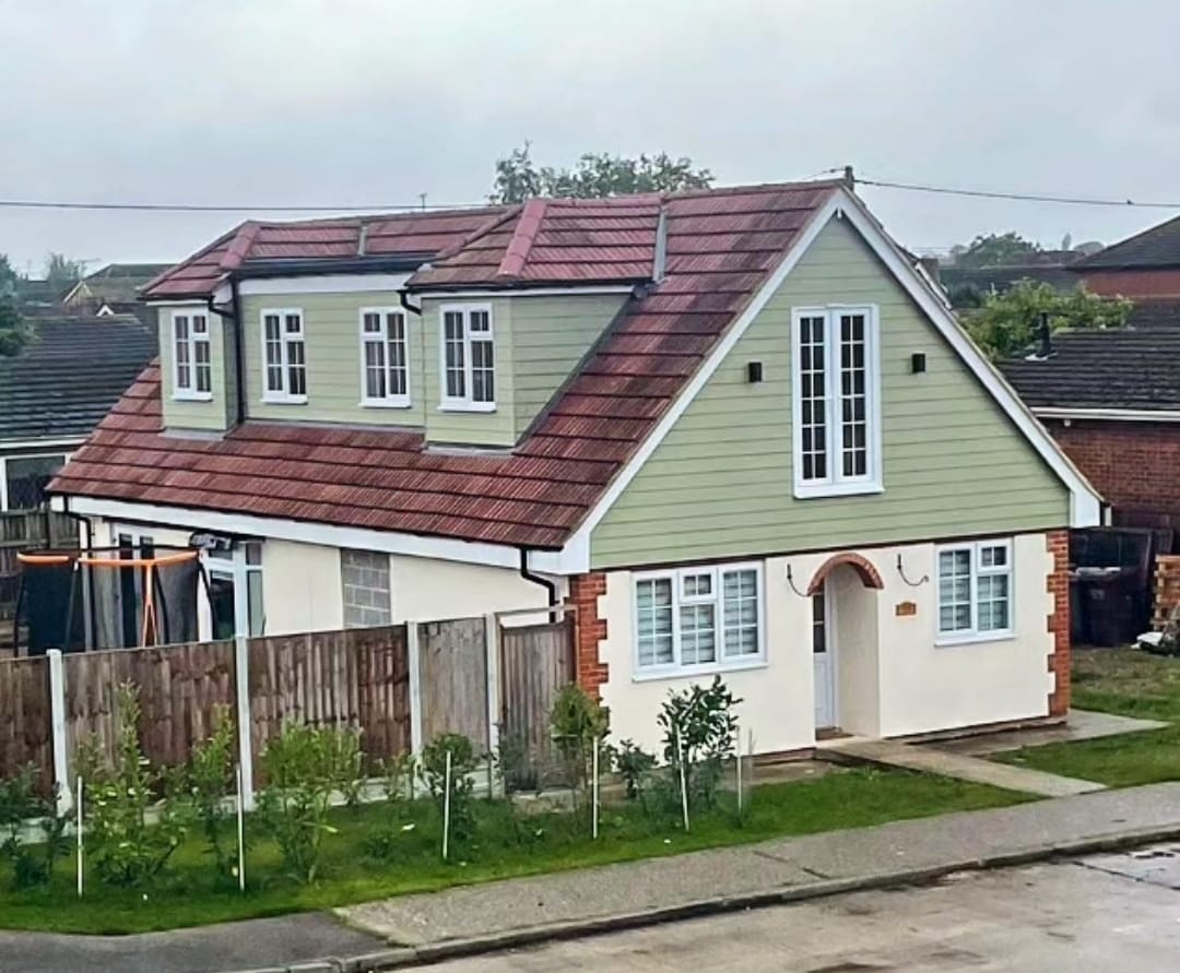 Completed full loft conversion with sage cladding and dormer windows